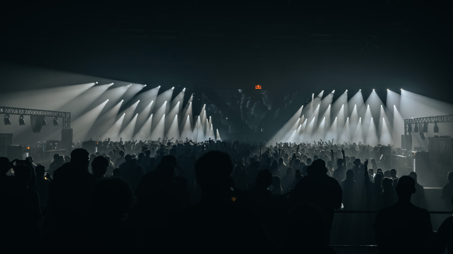 Crowd silhouetted under a wall of white spotlight beams — Bassment Festival, photographed by Paul Rumplmaier