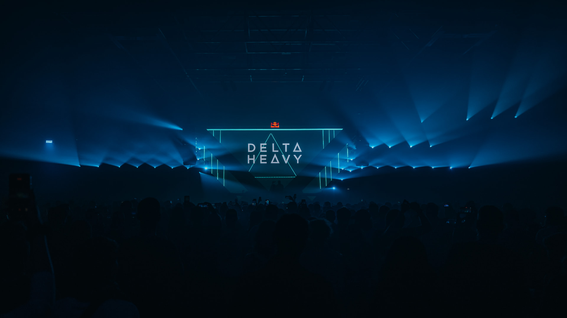 Delta Heavy set in deep blue light with lasers over the crowd — Bassment Festival, photographed by Paul Rumplmaier