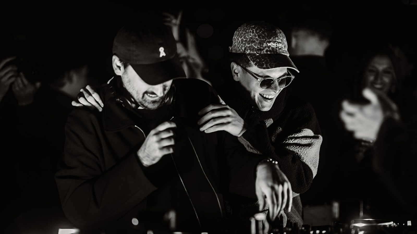 Two DJs laughing together during a back to back set — Bisou.at, photographed by Paul Rumplmaier