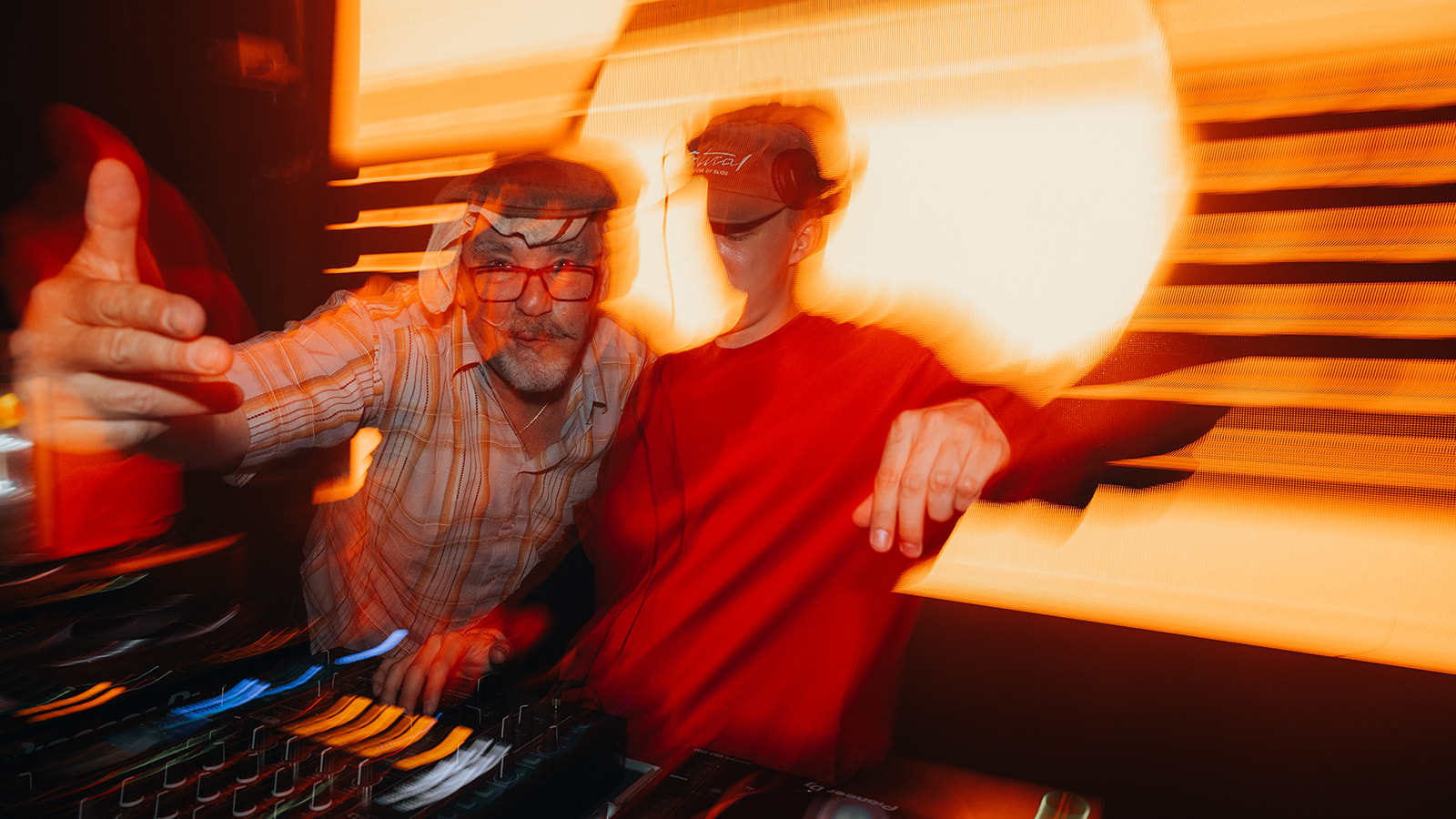 Motion blurred double exposure of two DJs behind the decks — Best of, photographed by Paul Rumplmaier