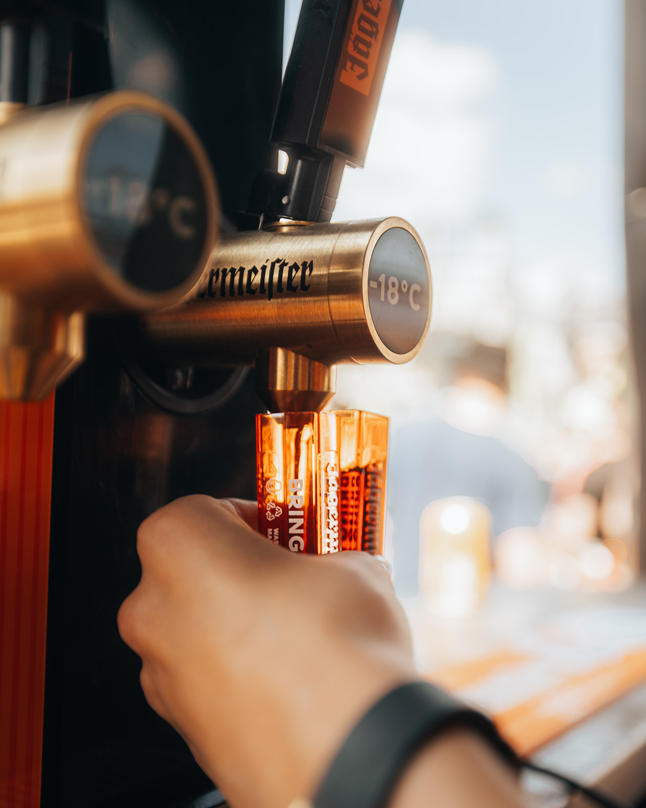 Hand pulling ice cold shots from the bar tap — Shutdown Festival, photographed by Paul Rumplmaier