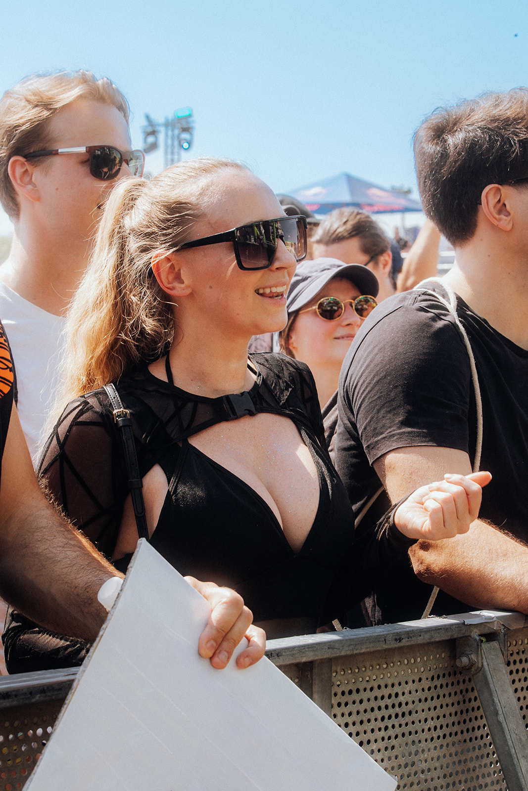 Smiling visitor in sunglasses at the front barrier in bright daylight — Shutdown Festival, photographed by Paul Rumplmaier
