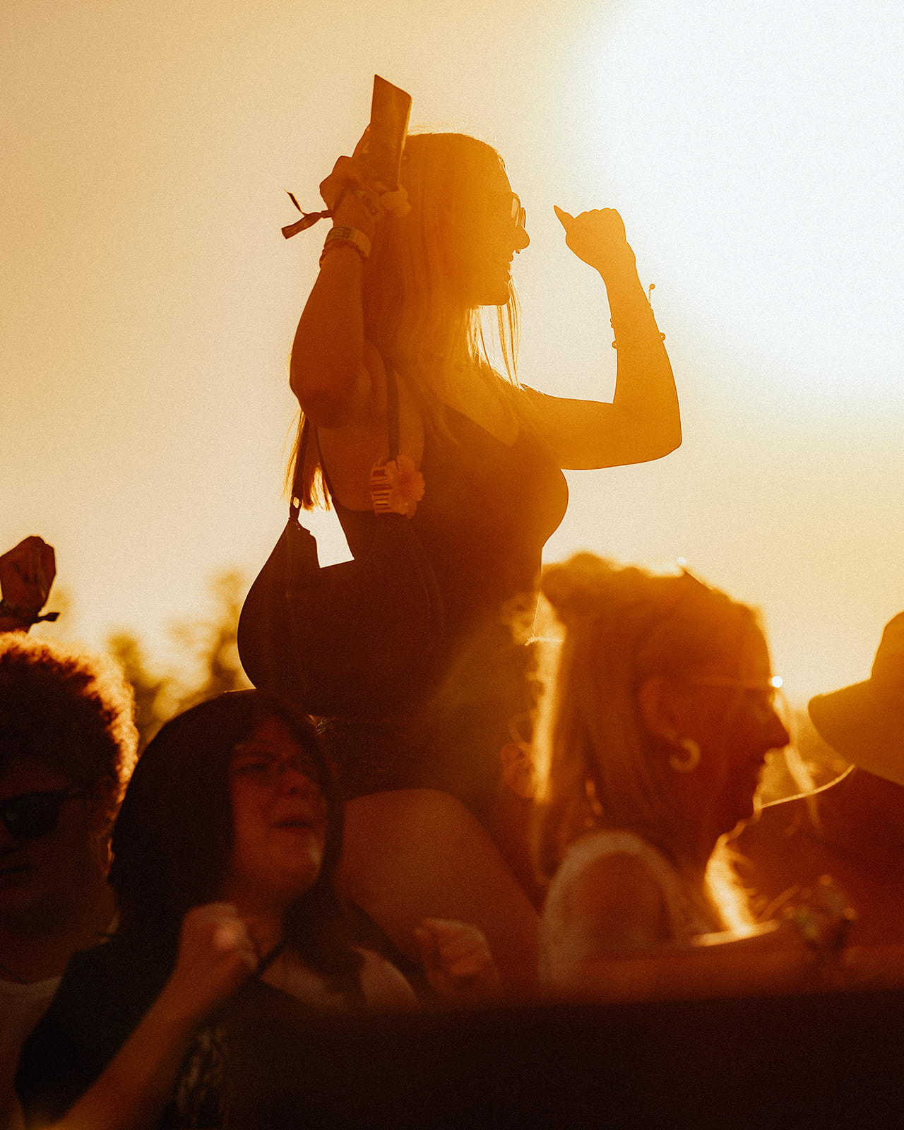 Silhouetted visitor on shoulders in golden evening backlight — Shutdown Festival, photographed by Paul Rumplmaier