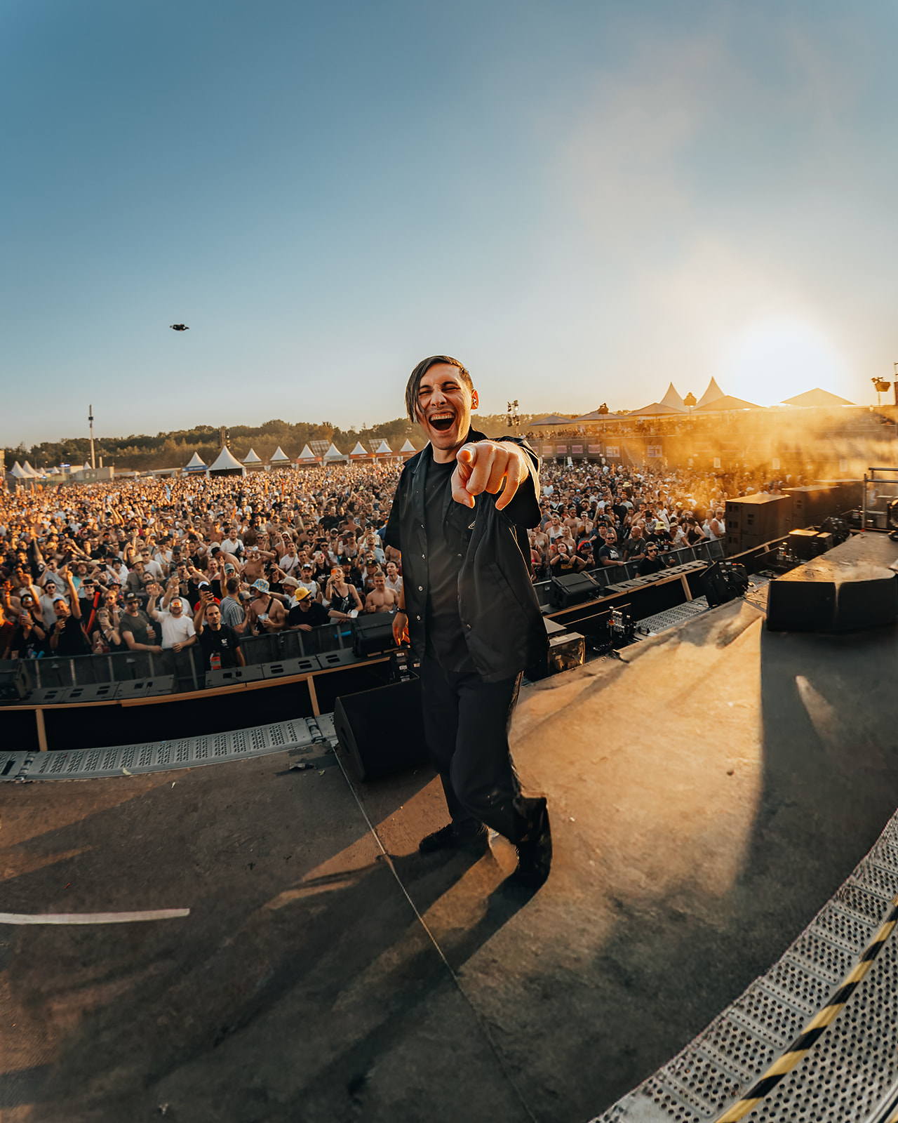 Artist laughing and pointing at the camera in front of the crowd — Shutdown Festival, photographed by Paul Rumplmaier