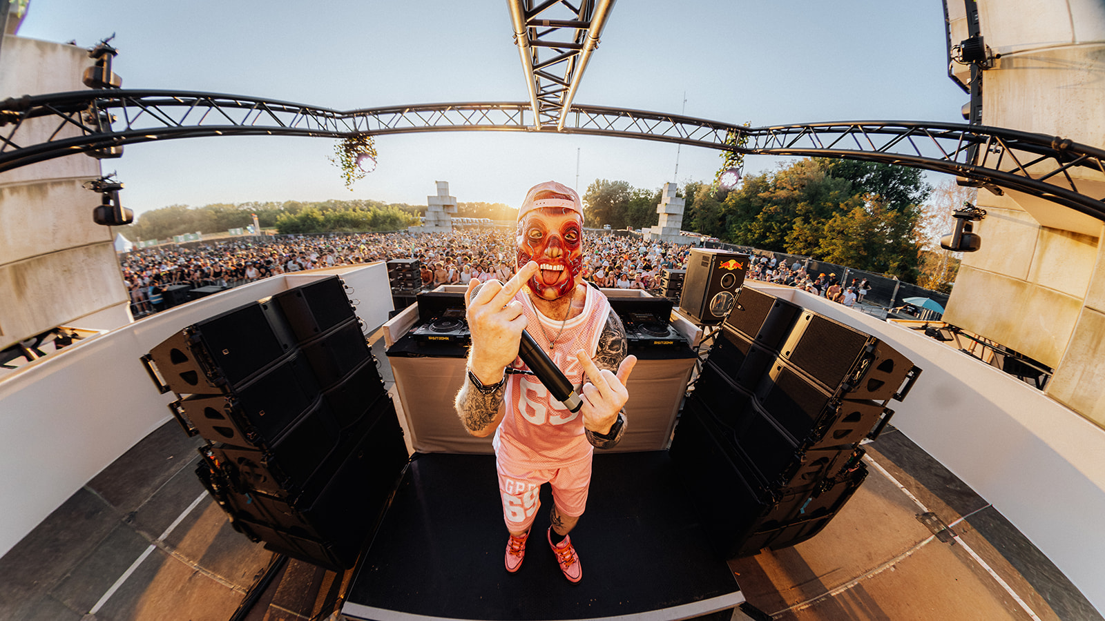 Fisheye frame of a masked artist on the reactor stage — Shutdown Festival, photographed by Paul Rumplmaier