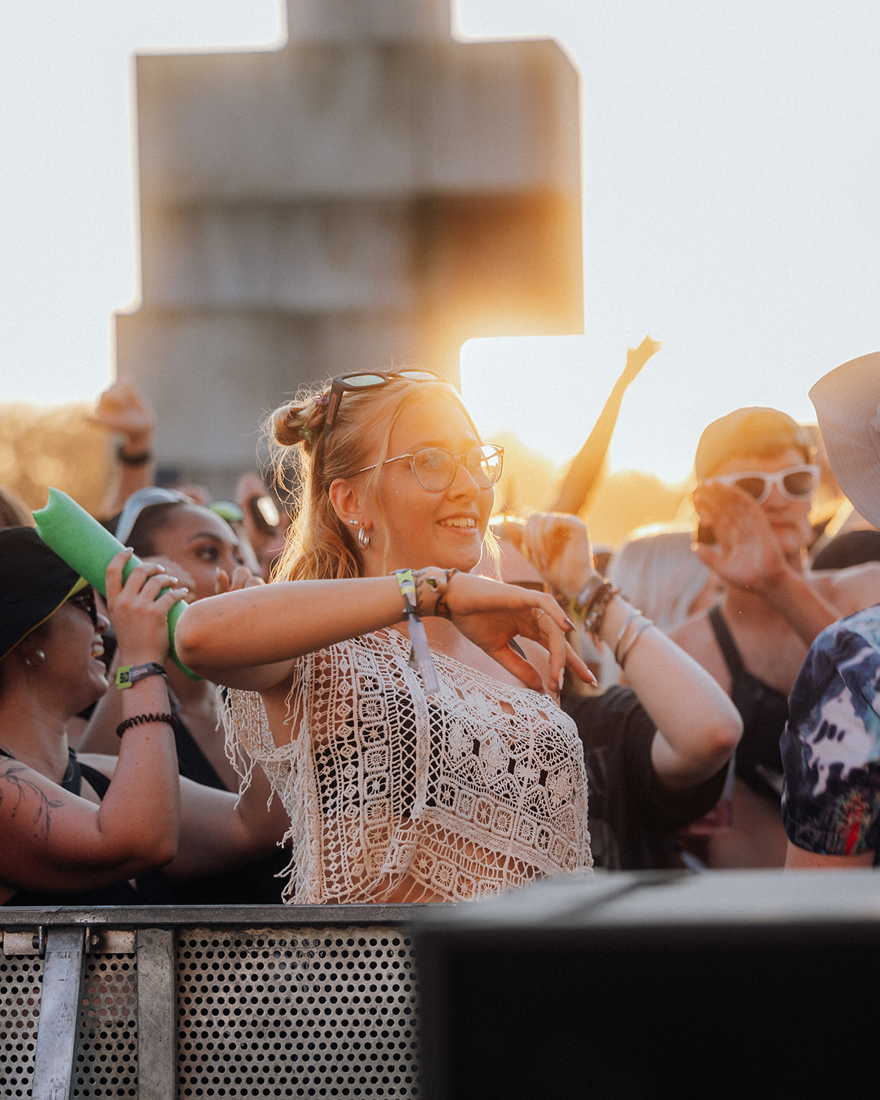 Visitor dancing at the front barrier in warm sunset light — Shutdown Festival, photographed by Paul Rumplmaier