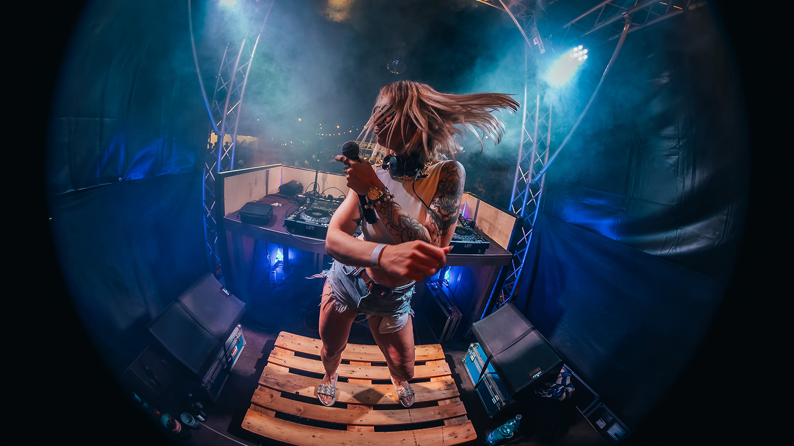 Fisheye frame of a DJ dancing with hair flying on an open air stage — Best of, photographed by Paul Rumplmaier
