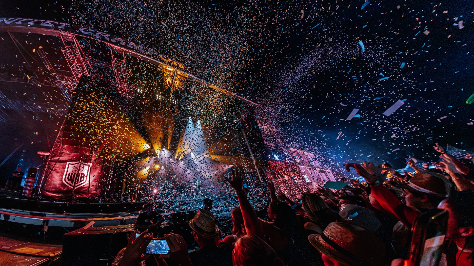 Confetti raining over the crowd at the main stage at night — Woodstock der Blasmusik, photographed by Paul Rumplmaier