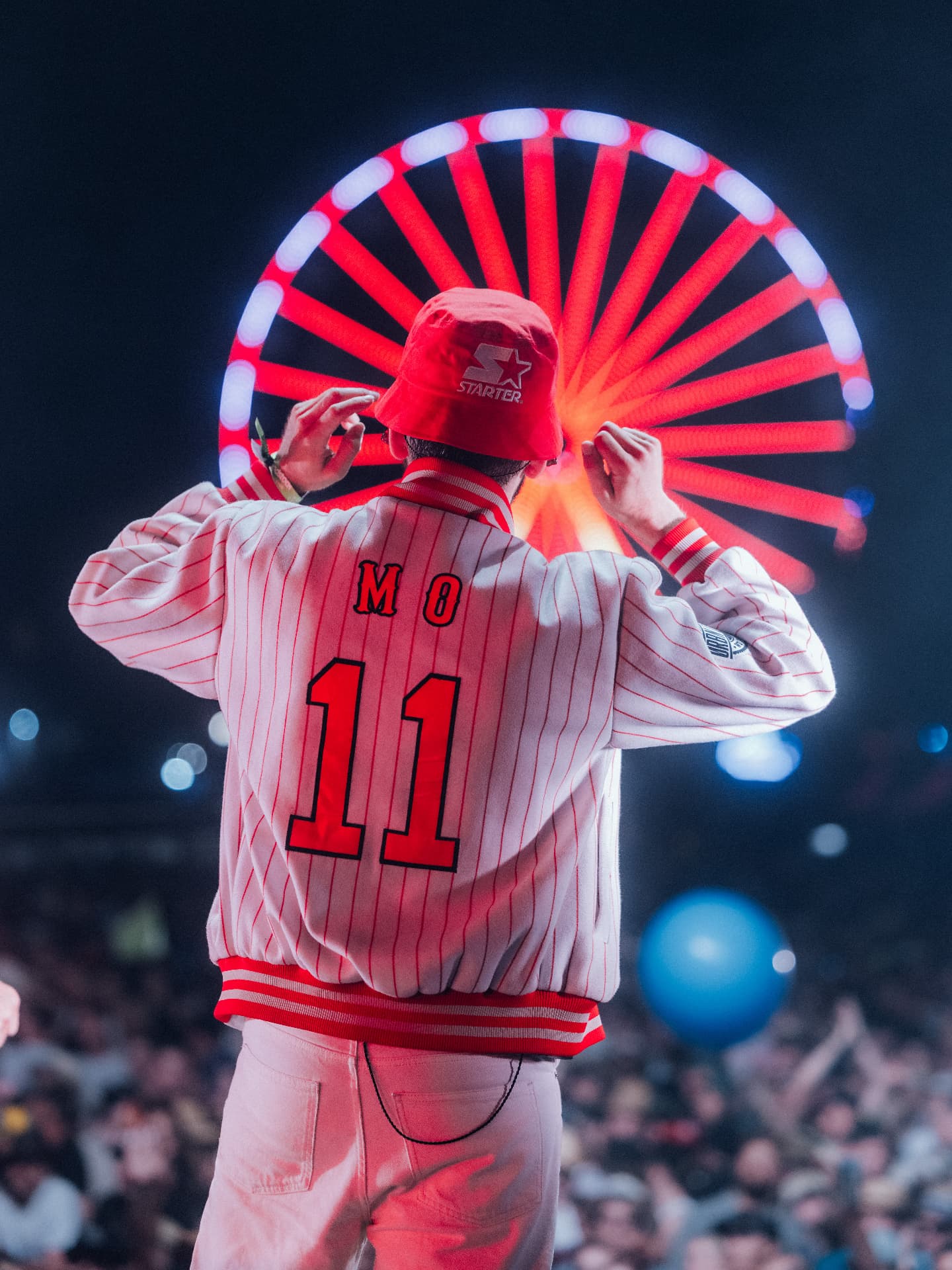 Artist on stage in front of a glowing red ferris wheel — Woodstock der Blasmusik, photographed by Paul Rumplmaier