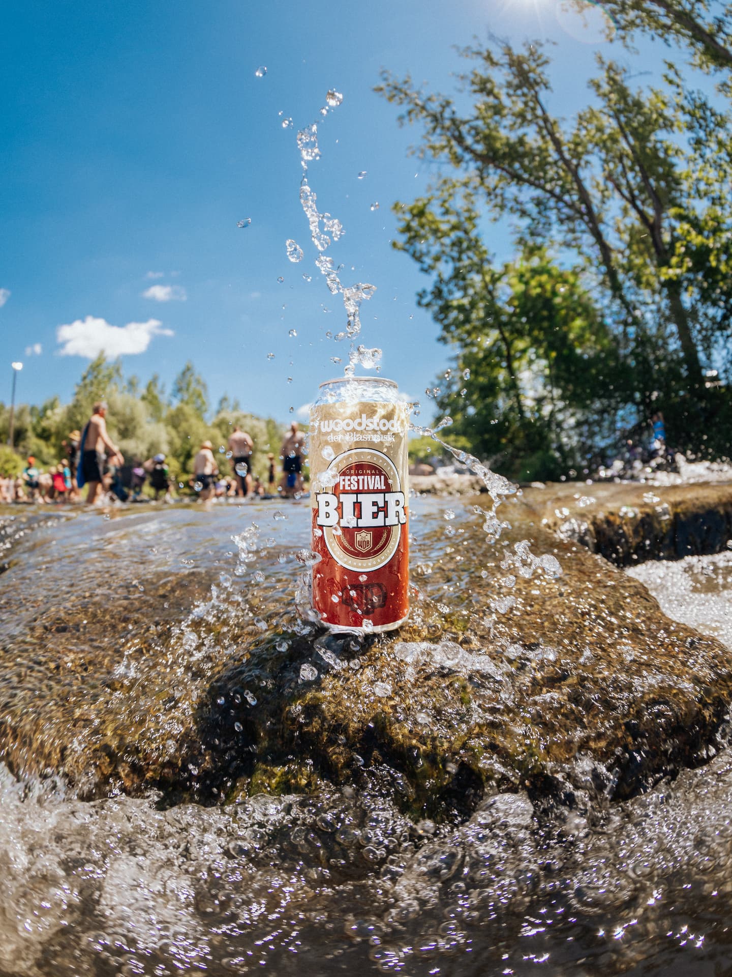 Festival beer can splashing in a creek on a summer day — Woodstock der Blasmusik, photographed by Paul Rumplmaier
